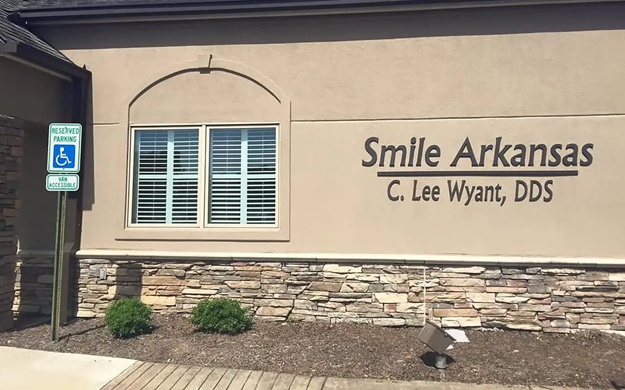 The Smile Arkansas building on Chenal Parkway, Little Rock, with the wall sign reading Smile Arkansas, C. Lee Wyant, DDS.