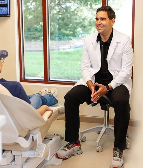 Dr. Jahon Zehtaban seated beside a patient in a Smile Arkansas treatment room.