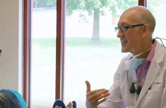 Dr. Lee Wyant talking a patient through her options in a treatment room.