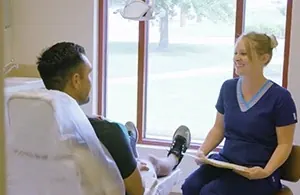 A hygienist with a patient in a Smile Arkansas treatment room.
